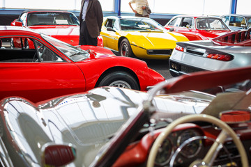 Old cars auction - People viewing cars on sale during an expensive old cars  auction