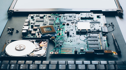 Laptop repair. Disassembled computer parts. PC electronic components. Closeup of keyboard, hdd, motherboard cpu