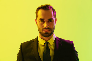 Poster - Image of brunette young businessman in formal suit looking at camera