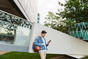 Wall Mural - Handsome young man dressed casually spending time outdoors