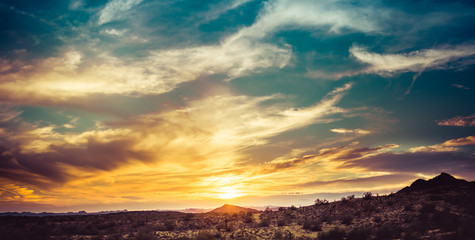 Wall Mural - A sunset over the Sonoran Desert of Arizona with high altitude clouds panorama.