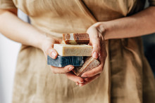 A Woman Holding Soaps