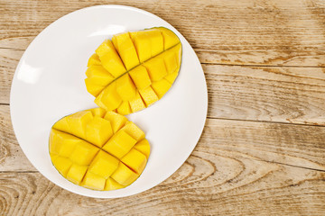 Wall Mural - fresh juicy yellow mango with a child hand on it 