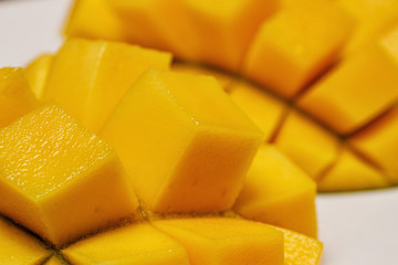 Wall Mural - fresh juicy yellow Thai chopped mango on the table 