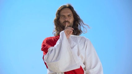 Poster - Jesus showing silence gesture on sky background, speechless prayer, deep faith