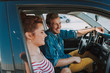 © Yakobchuk Olena - Cheerful man and young woman sitting in the car