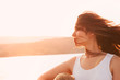 © Cavan for Adobe - Woman with tousled hair at sunset