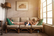 © Cavan for Adobe - Mother and daughter relaxing on sofa