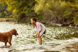 © Cavan for Adobe - Girl playing with her dog on lakeshore