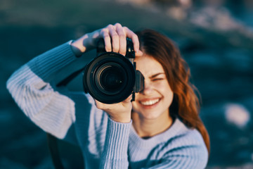 young woman taking photo with digital camera