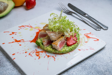 Canvas Print - Tuna tar tar with mashed avocado on white plate