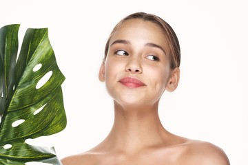 Wall Mural - portrait of young woman with green leaf