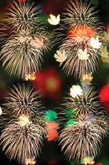 Wall Mural - colorful firework and bokeh with copy space for merry christmas and new year celebration background