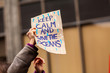 © Valmedia - Ecological protest sea pollution poster. An ecological activist holds a homemade placard saying keep calm and save the oceans on an urban street during a climate change protest.