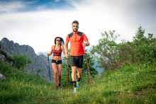 Sporty Couple In The Mountains With Nordic Walking Poles