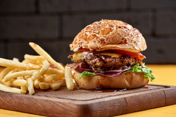 burger with onion rings, cheese and jack daniel's sauce