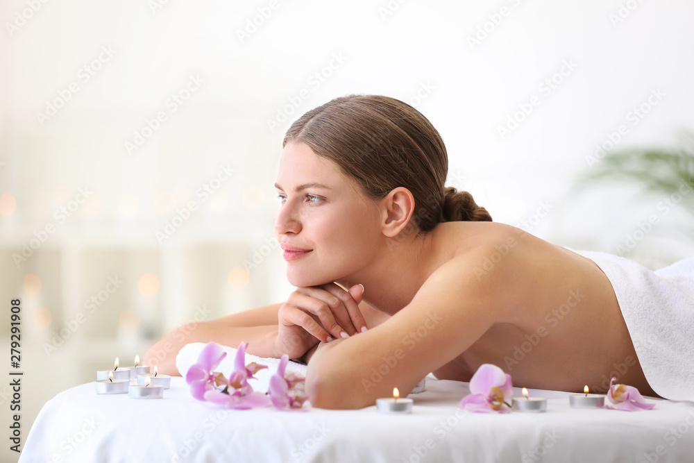 Beautiful young woman relaxing in spa salon
