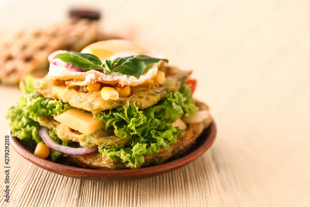 Plate with tasty squash waffles and fried egg on wooden table