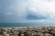 Storm with tornado in Rimini, Italy. Picturesque landscape view with sea, clouds, cityscape and whirlwind. Natural disaster. Mediterranean Sea.