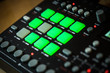 © Victor Lucas - Electronic music production with a drum machine. Green pads trigger different drum sounds.