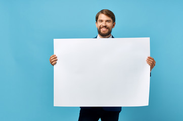 man holding a white blank on a blue background