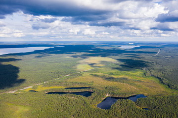 Highway Scandinavia from a bird's eye view. In the frame of the forest, lakes, highway.