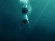 Man Jumping Into The Water. Underwater Shot. Vacation, Sports And Active Lifestyle Concept.