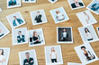 photos with men and women employees on wooden table