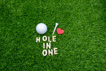 Golf Hole In One With Golf Ball And Tee On Green Grass.