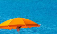 Orange Beach Umbrella By The Sea In Summer Day