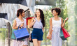 © Syda Productions - sale, consumerism and people concept - happy young women with shopping bags walking along city street