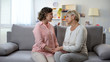 © motortion - Sad mature woman and daughter holding hands and looking at each other, support