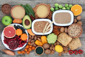 Wall Mural - Healthy high fibre food concept with fruit, vegetables, grains, nuts, seeds, seeded wholegrain rolls & spirulina powder. Foods with antioxidants, anthocyanins, vitamins & minerals. Top view.