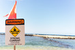 © Sarah Rypma - Sign warning about strong current on beach