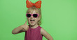 Positive girl in purple dress, sunglasses and red ribbon. Smile. Thumbs up