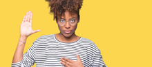 Beautiful Young African American Woman Wearing Glasses Over Isolated Background Swearing With Hand On Chest And Open Palm, Making A Loyalty Promise Oath