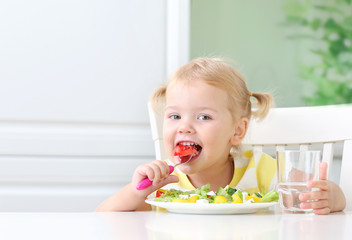 Little child eating healthy food vegetables salad,kid's nutrition.