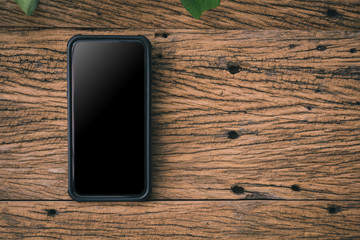 Aufkleber - Smart phone on wooden background with copy space. top view.