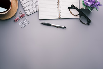 Aufkleber - Flat lay, top view office table desk. Workspace with keyboard, office supplies, pencil, green leaf, and coffee cup on gray background.