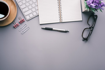 Aufkleber - Flat lay, top view office table desk. Workspace with keyboard, office supplies, pencil, green leaf, and coffee cup on gray background.