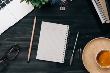Aufkleber - Modern dark wood office desk table with laptop, smartphone and other supplies with cup of coffee. Blank notebook page for input the text in the middle. Top view, flat lay.