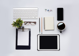 Aufkleber - top view of White office desk table with laptop, smartphone and other supplies with cup of coffee. Blank notebook page for input the text in the middle. Top view, flat lay.