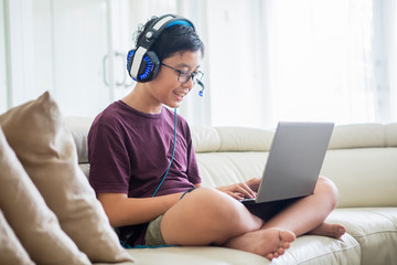 Preteen boy uses a laptop for playing online games