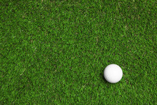 Golf Ball On Green Artificial Grass, Top View With Space For Text