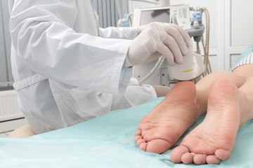 Wall Mural - Doctor conducting ultrasound examination of patient's foot in clinic, closeup