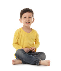 Sticker - Portrait of cute little boy sitting on white background