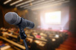 © nattanan - Microphone over the blurred business forum Meeting or Conference Training Learning Coaching Room Concept, Blurred background.