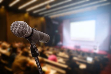 microphone over the blurred business forum meeting or conference training learning coaching room con