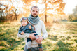 © benevolente - Happy father posing with his stylish child in autumn park