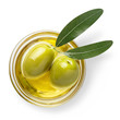 Delicious green olives in an olive oil with leaves, isolated on white background, view from above